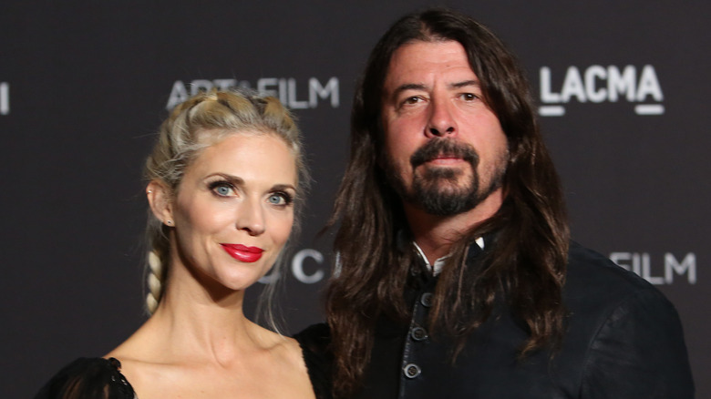 Dave Grohl and Jordyn Blum smiling together at event