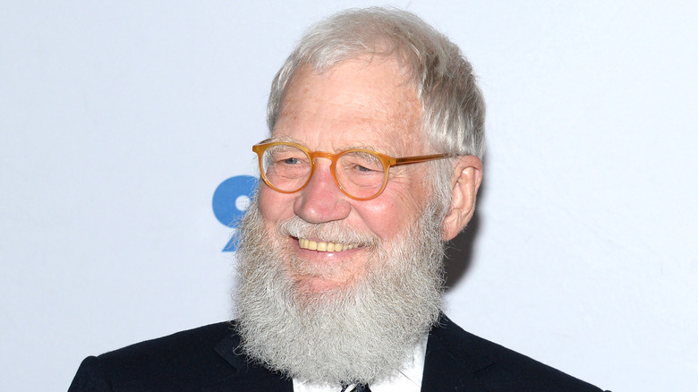 Bearded David Letterman smiling in suit at event