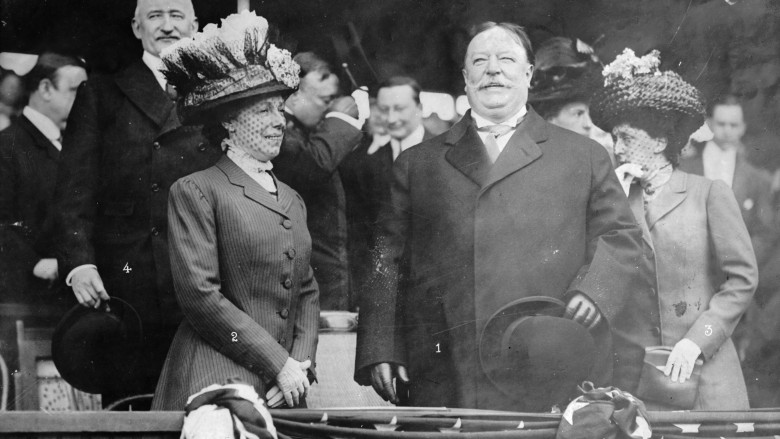 President William Taft stood in suit smiling in crowd