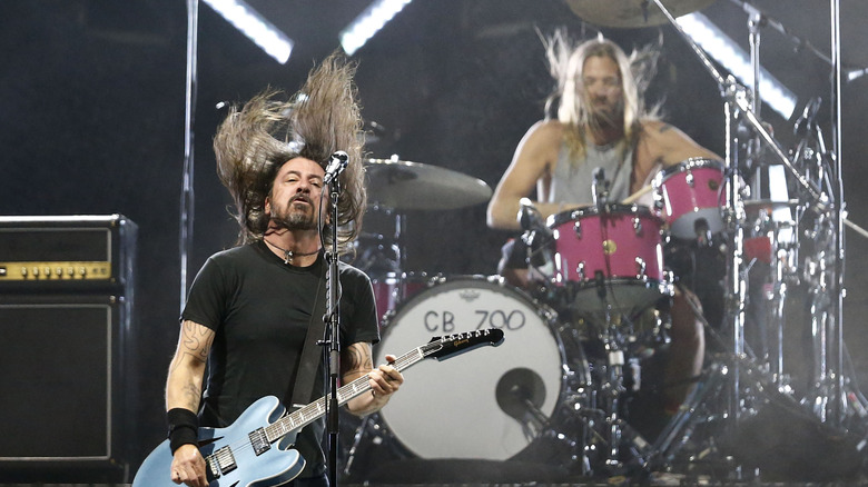 Dave Grohl playing guitar and Taylor Hawkins on drums performing on stage