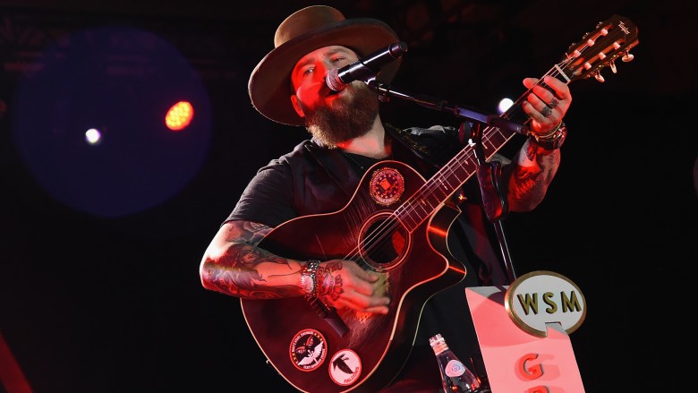 Bearded Zac Brown playing guitar and singing on stage