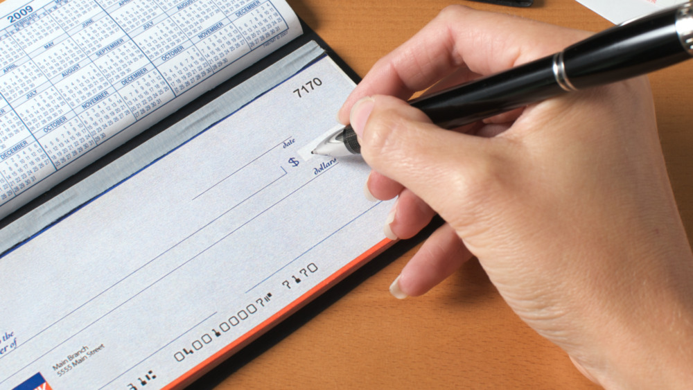 Hand with checkbook