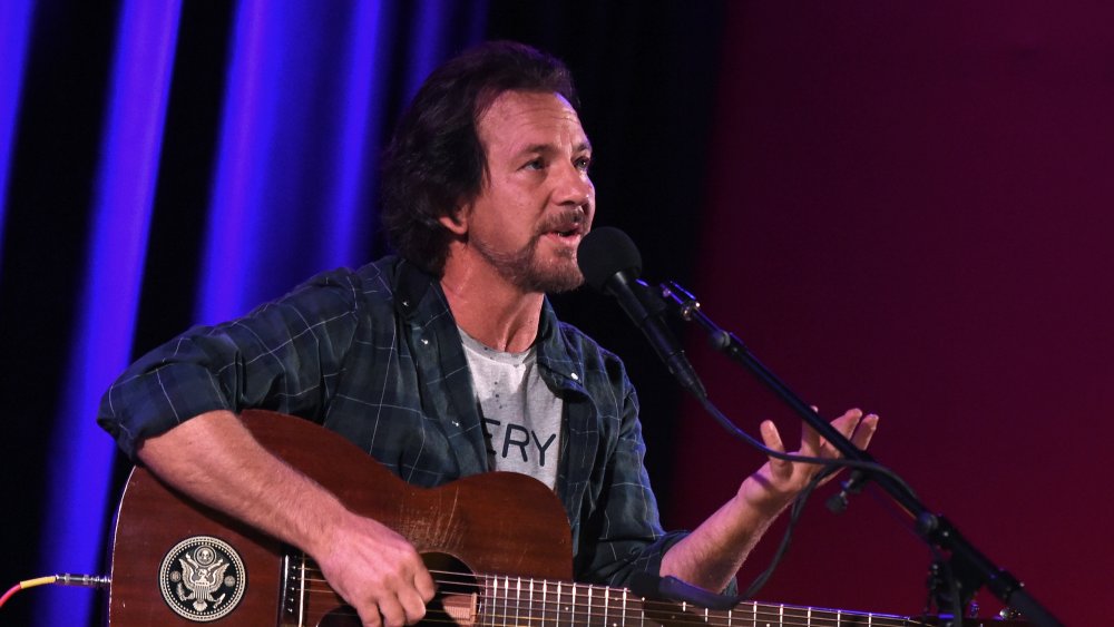 Eddie Vedder on stage mic guitar talking