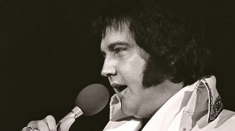 Elvis Presley singing on stage in 1977