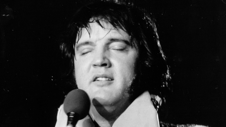 elvis presley singing into microphone eyes closed