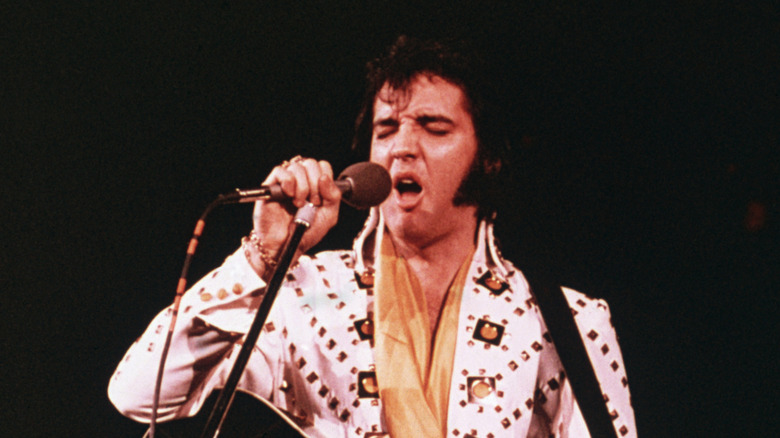 Elvis Presley singing on stage in the 1970s