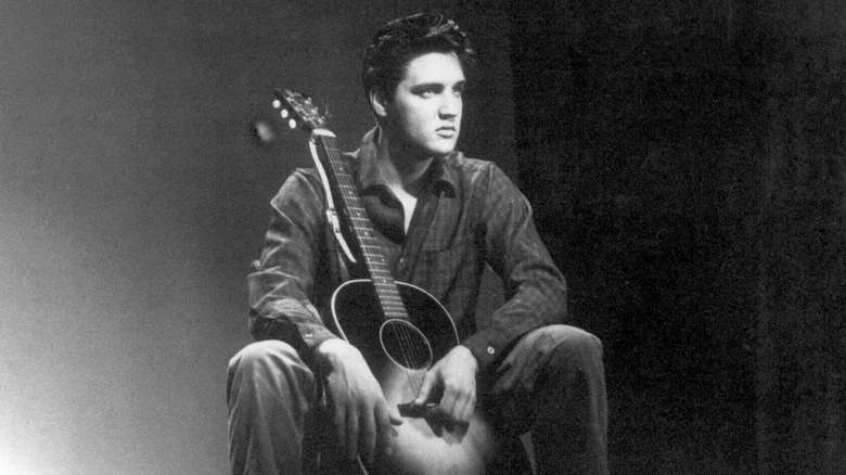 Elvis Presley posing with guitar