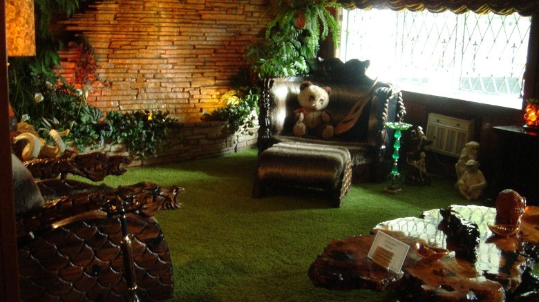 A teddy bear relaxes in the Jungle Room
