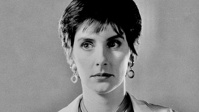 Enya looking sideways big earrings