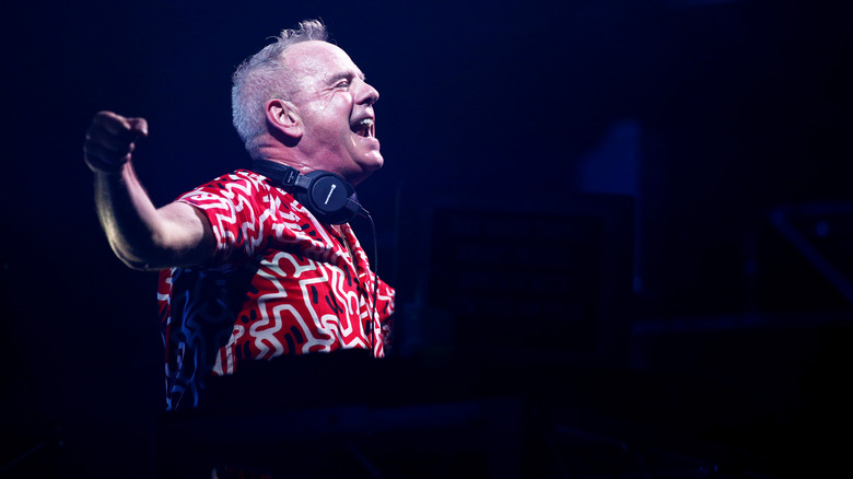 Fatboy Slim black background performing on stage