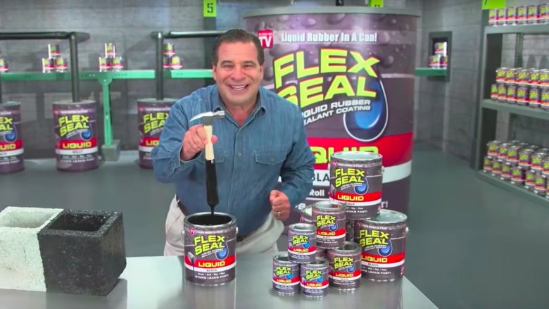 Phil Swift with cans of Flex Seal
