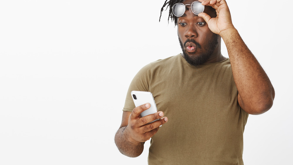 Man surprised at phone.
