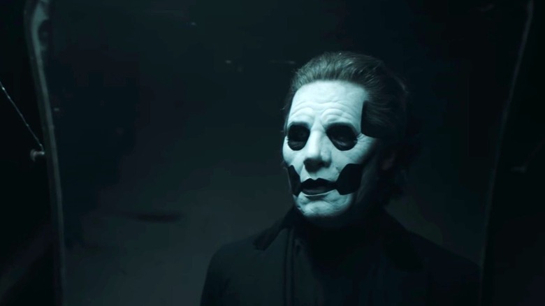 Papa Emeritus face paint looking in the mirror