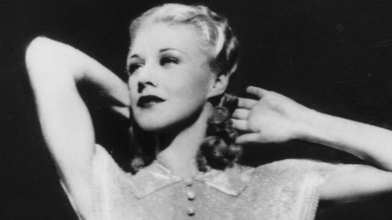 Ginger Rogers posing with arms behind head