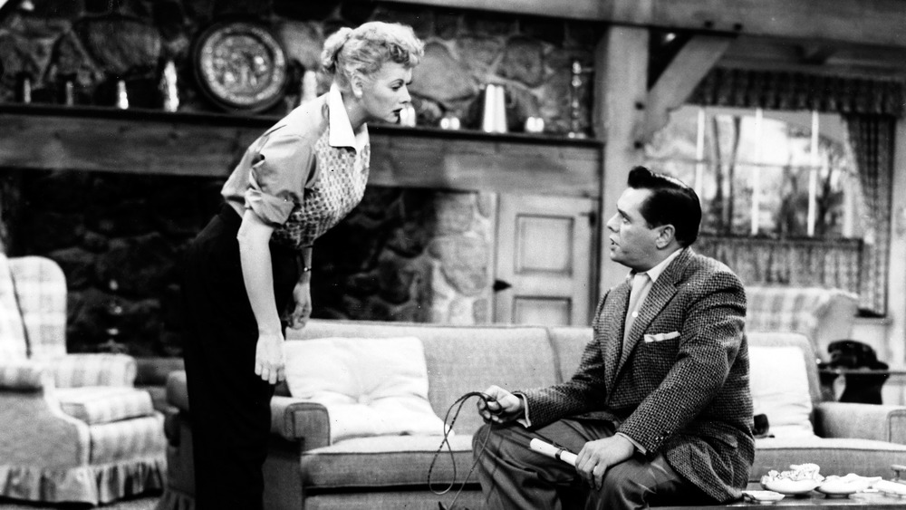 Lucy and Ricky in their living room talking 