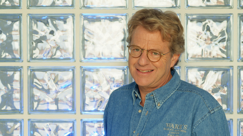 Jerry Springer in front of glass wall