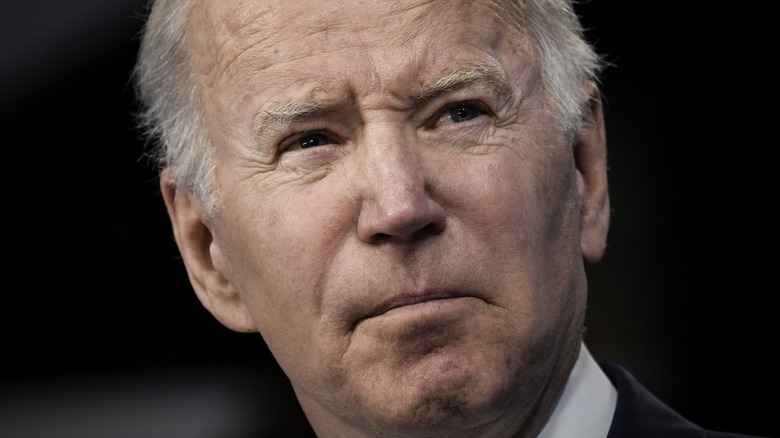 Joe Biden staring black background