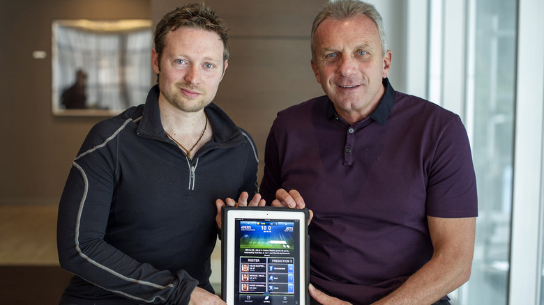 Damon Grow and Joe Montana posing with iPad