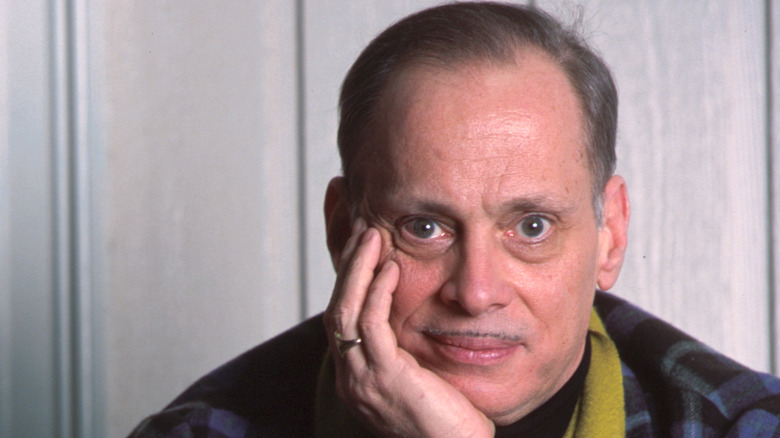 John Waters rests head on hand