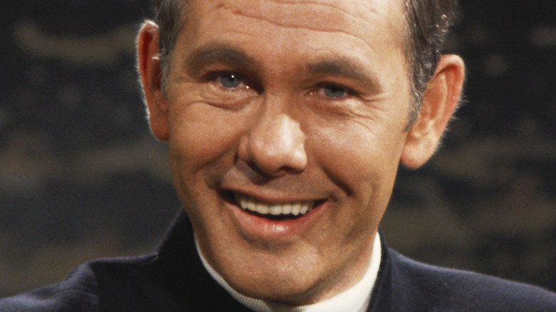 Johnny Carson sitting at his desk