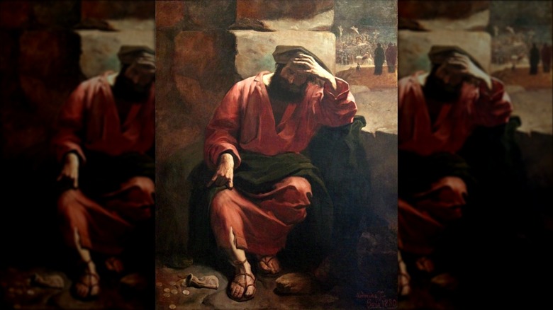 Judas sitting hand on forehead