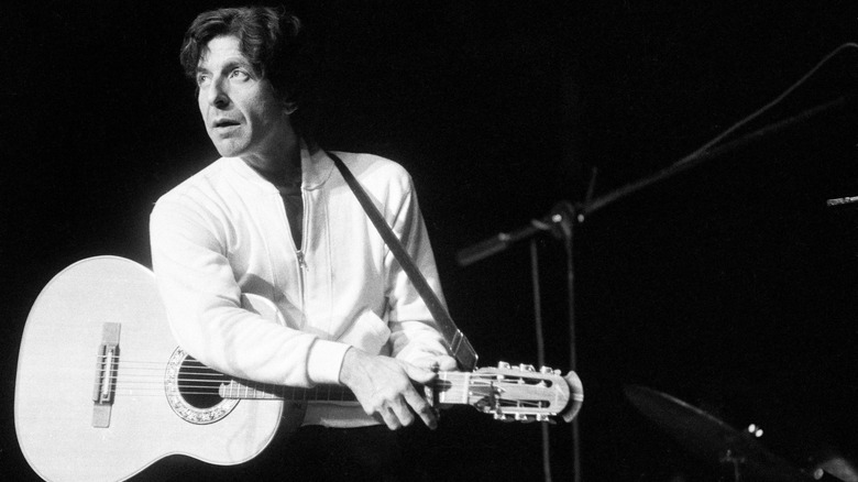 Leonard Cohen playing the guitar