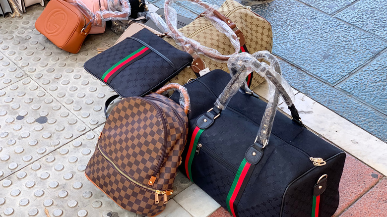 Counterfeit Bags laying on Sidewalk