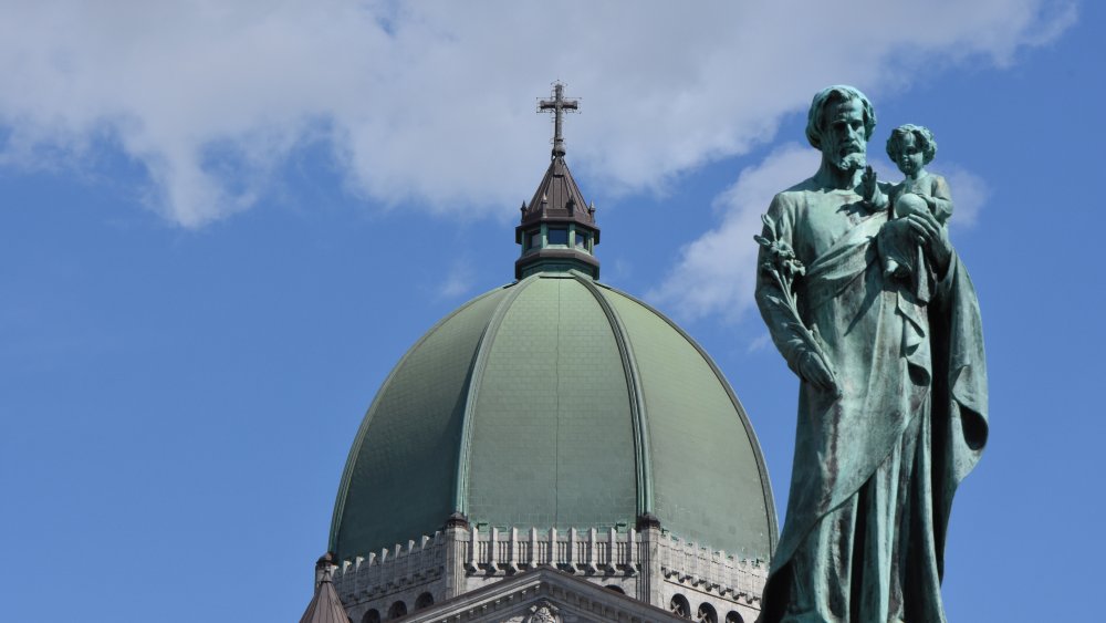 statue of Saint Joseph and Jesus in front of Basilica