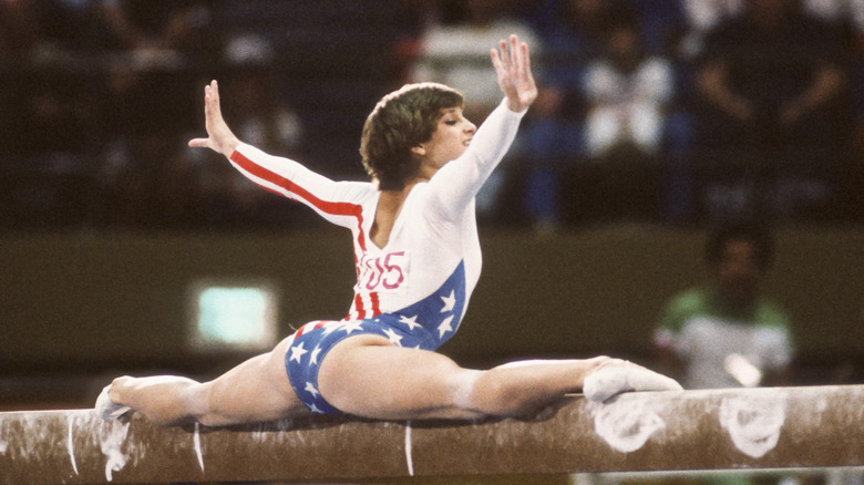 Retton performing beam arms raised smiling