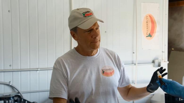 Mike Rowe white shirt hat black gloves
