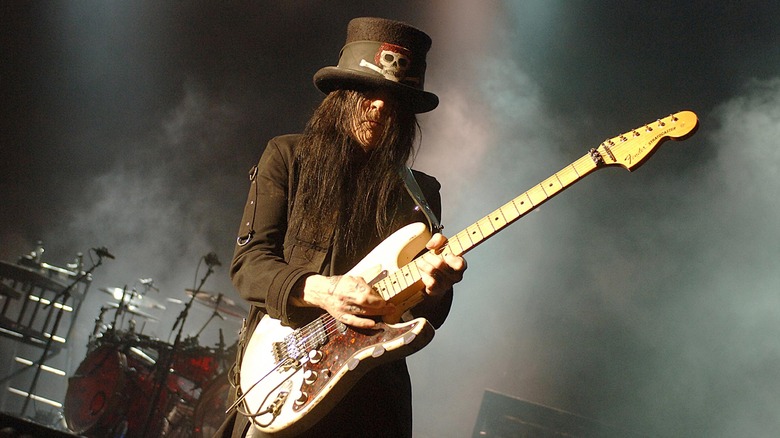 Older Mick Mars performing