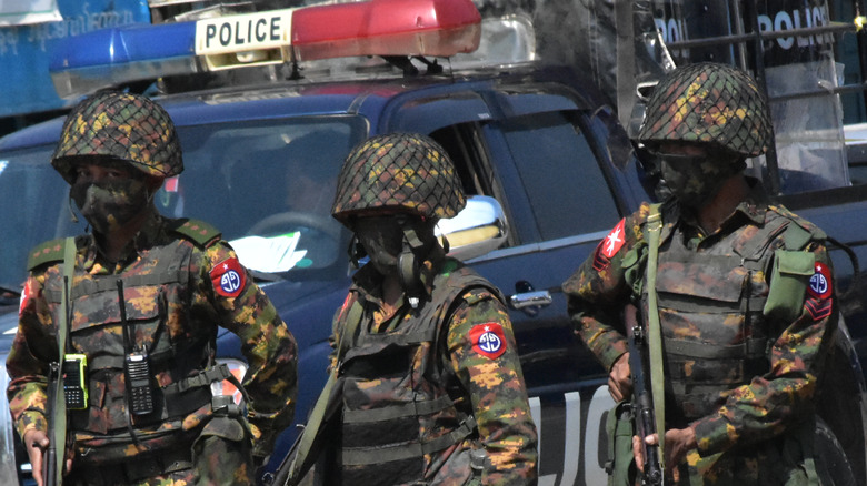 Police and soldiers block off a road during the 2021 coup