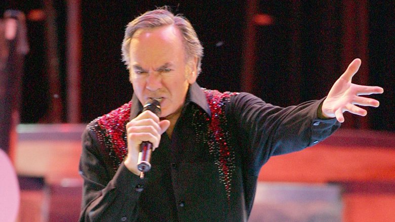 Neil Diamond on stage mic arm extended