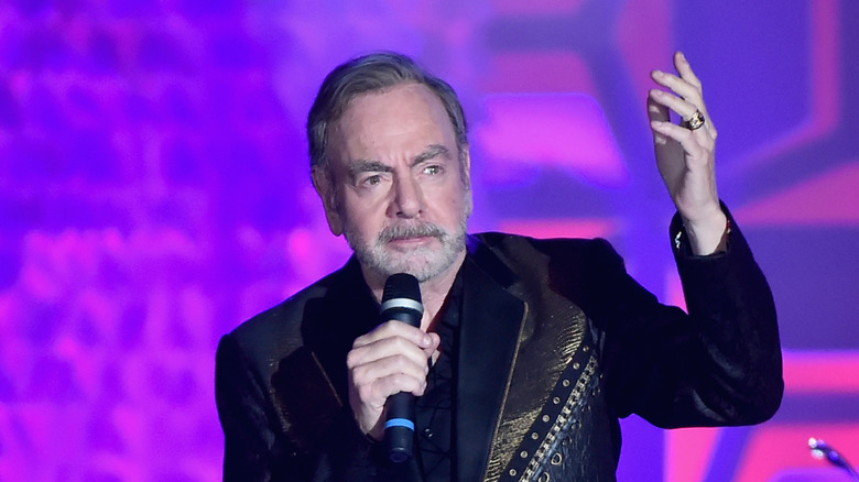 Neil Diamond on stage mic arm raised