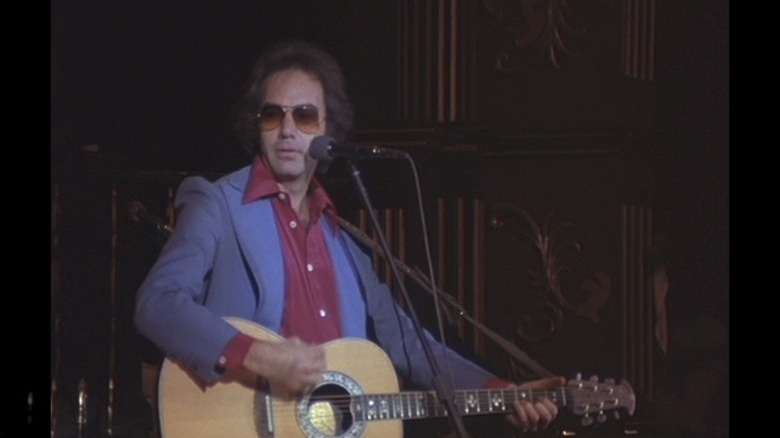 Neil Diamond blue jacket on stage guitar