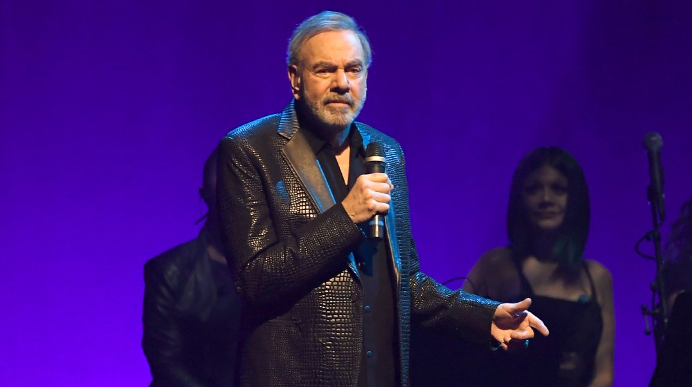 Neil Diamond leather jacket on stage holding mic