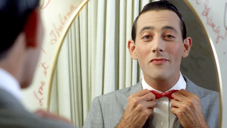 Paul Reubens looking in a mirror as Pee-wee Herman