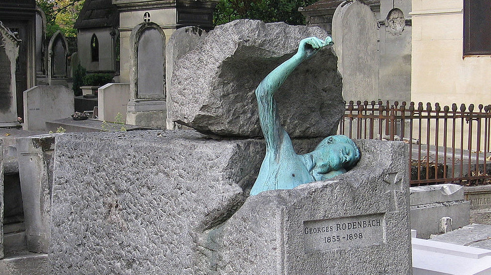 Georges Rodenbach grave with have submerged sculpture
