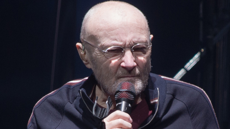 Phil Collins performing seated in 2022