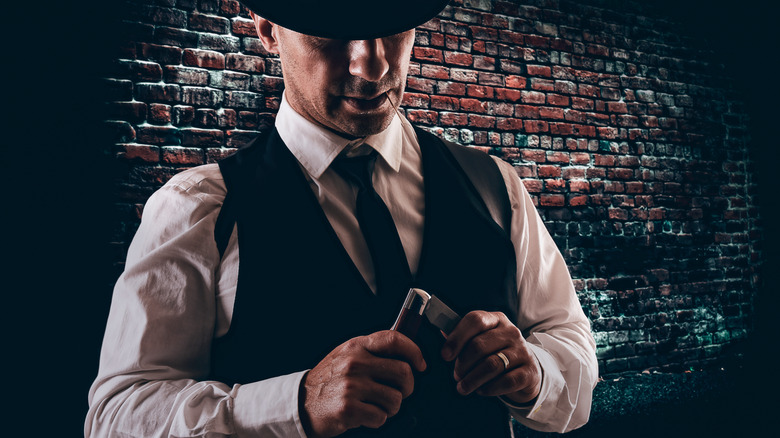gangster playing with his knife