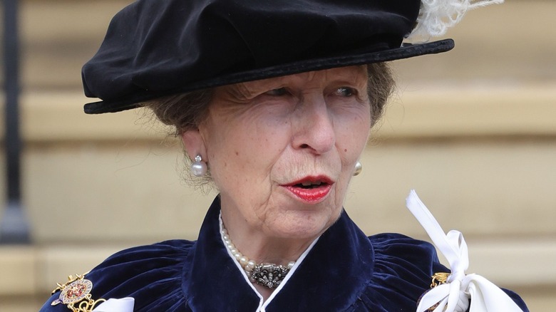 Princess Anne walks in the robes of the Order of the Garter