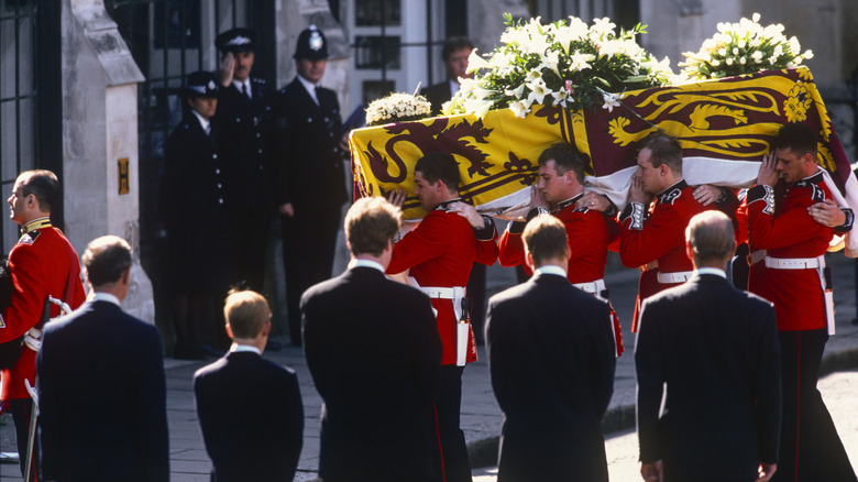 Guardsmen of the Prince of Wales Company of the Welsh Guards carry Princess Diana's coffin into Westminster Abbey