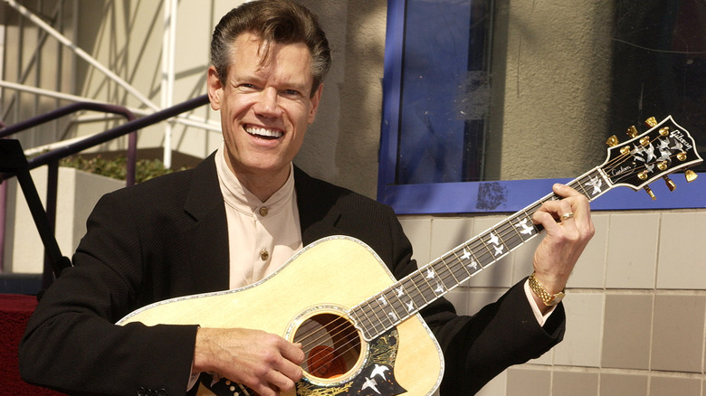 Randy Travis playing guitar