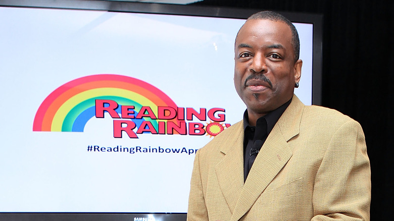 LeVar Burton in front of Reading Rainbow logo