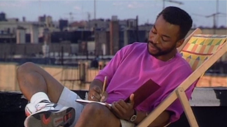 LeVar Burton writes in a notebook