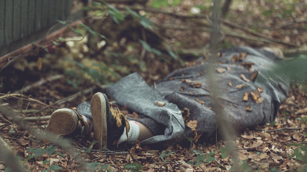 Dead body wrapped in tarpulin