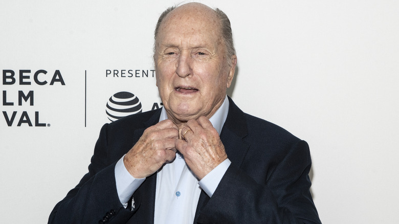 Robert Duvall adjusting his shirt at event