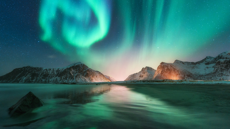 Aurora borealis over an icy landscape.
