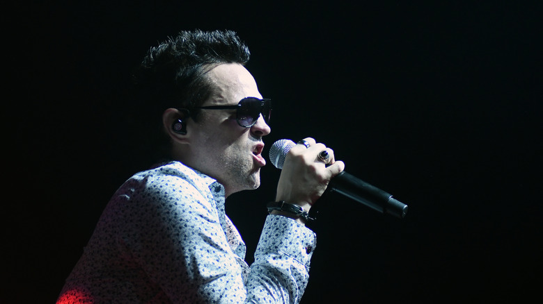 Jeff Gutt holding mic singing