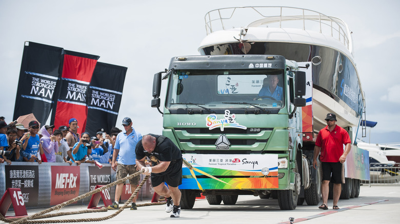 Brian Shaw pulling a truck and a yacht
